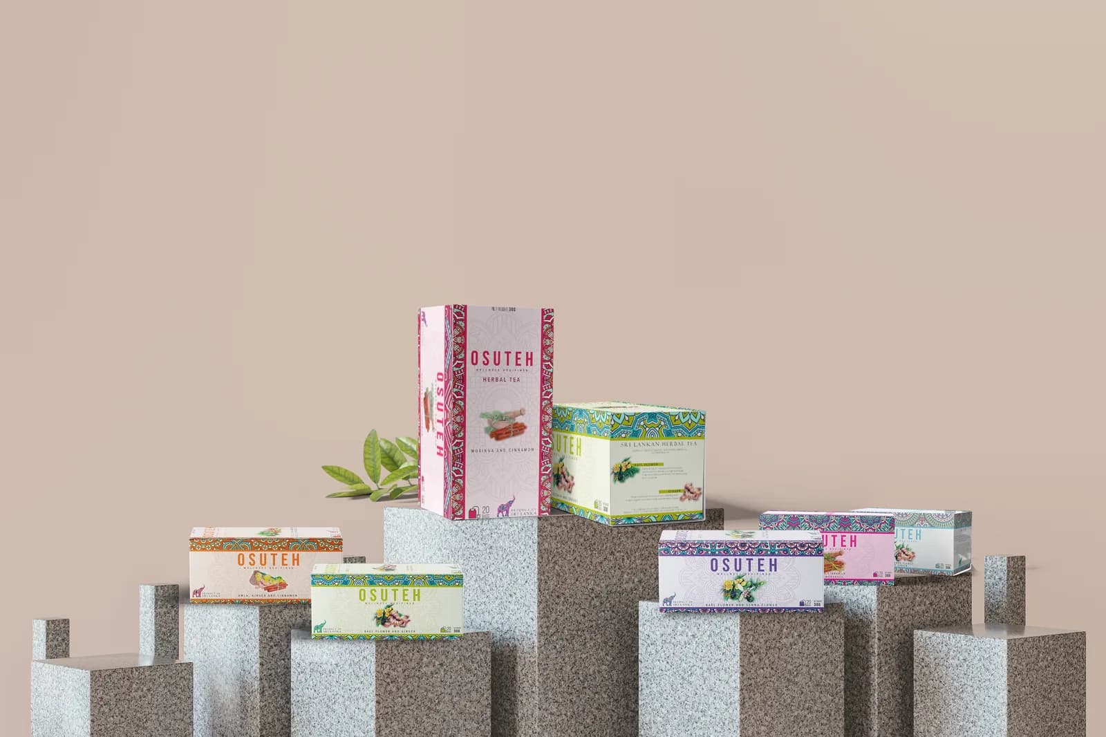 Seven OSUTEH tea boxes in different colourways on stone plinths against a warm beige wall.